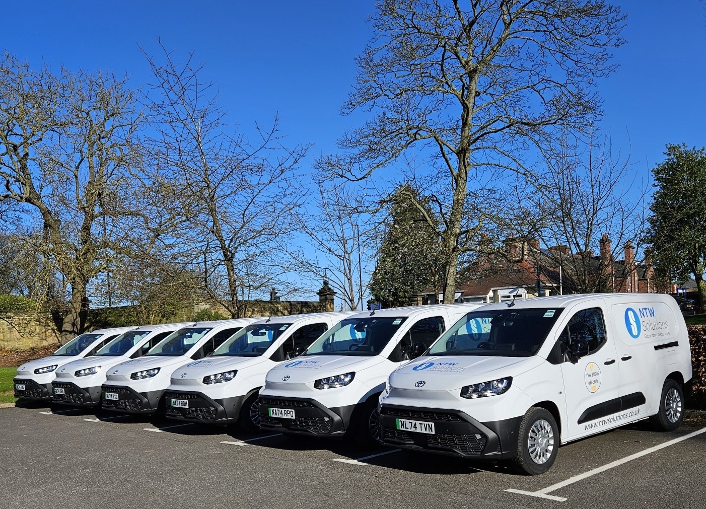 Photo of the electric van fleet, white vans in a car park