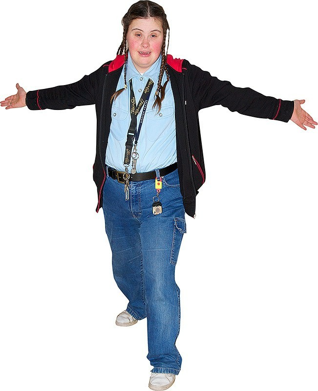 A girl with her arms outstretched and one leg in front of the other