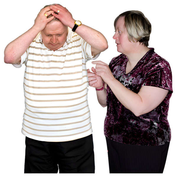 A person looking down at the floor with their hands on their head. Beside them is another person offering support.