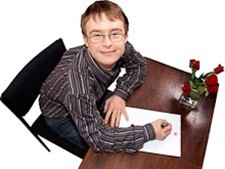 A person sitting a desk writing