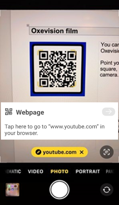 QR code on a phone showing a yellow YouTube link