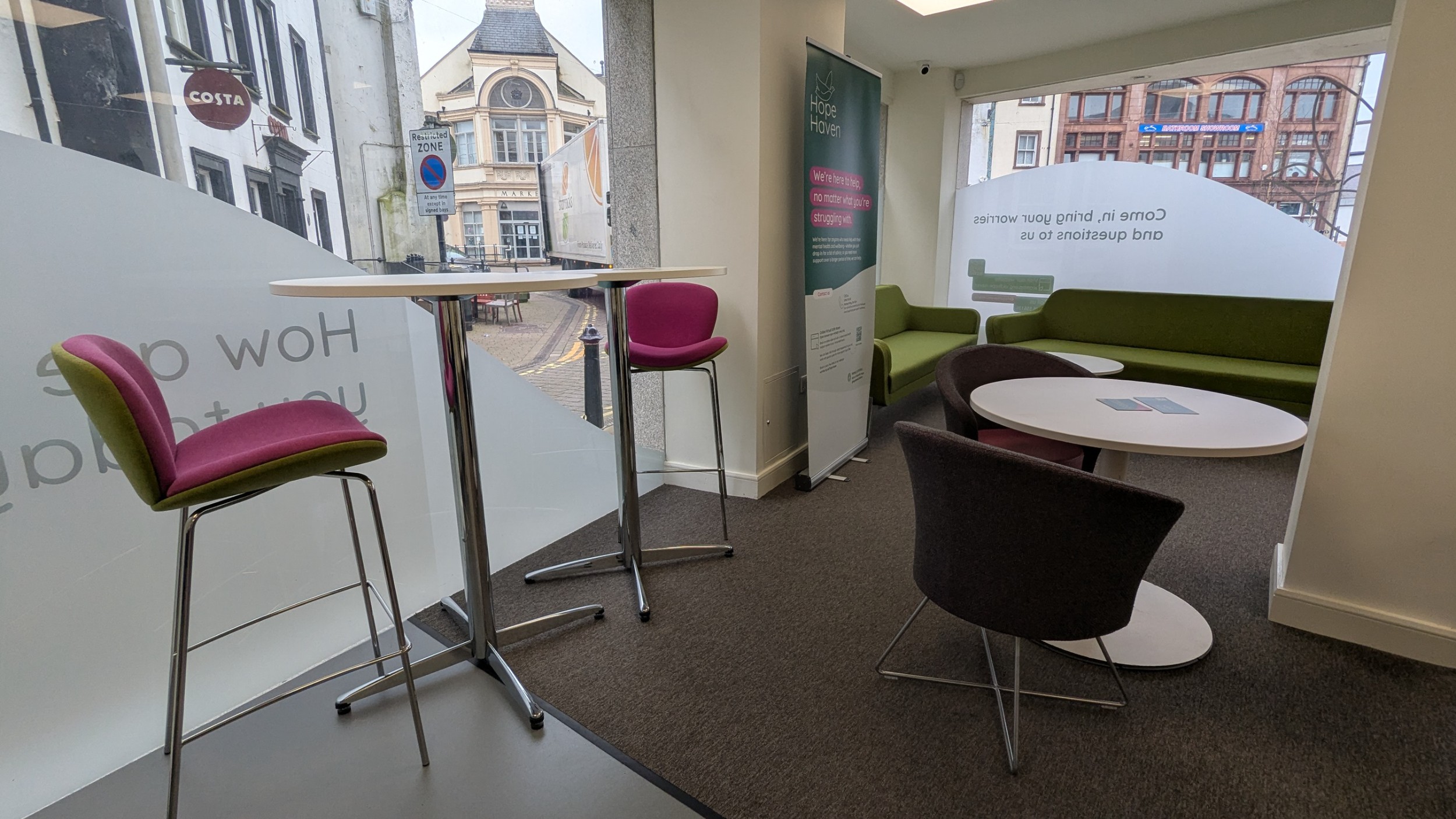The 'welcome area' at Hope Haven, with comfy chair, sofas, and large windows letting in lots of sunlight