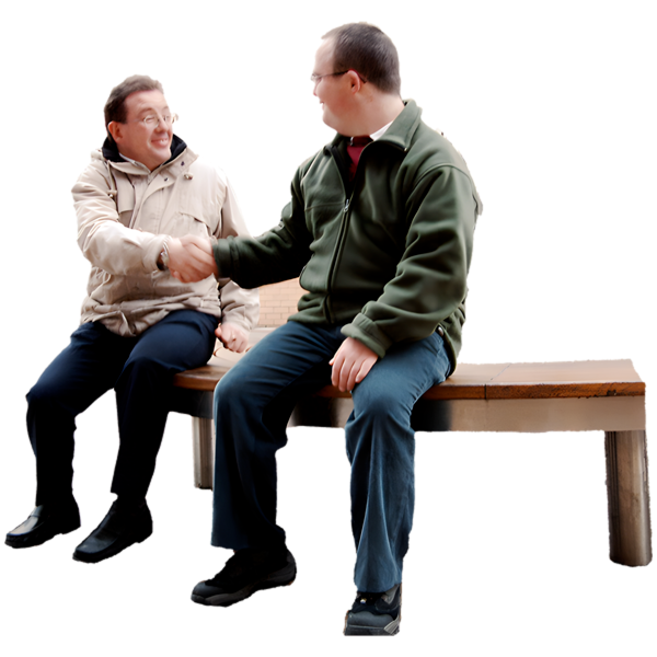 Two men sitting on a bench shaking hands.