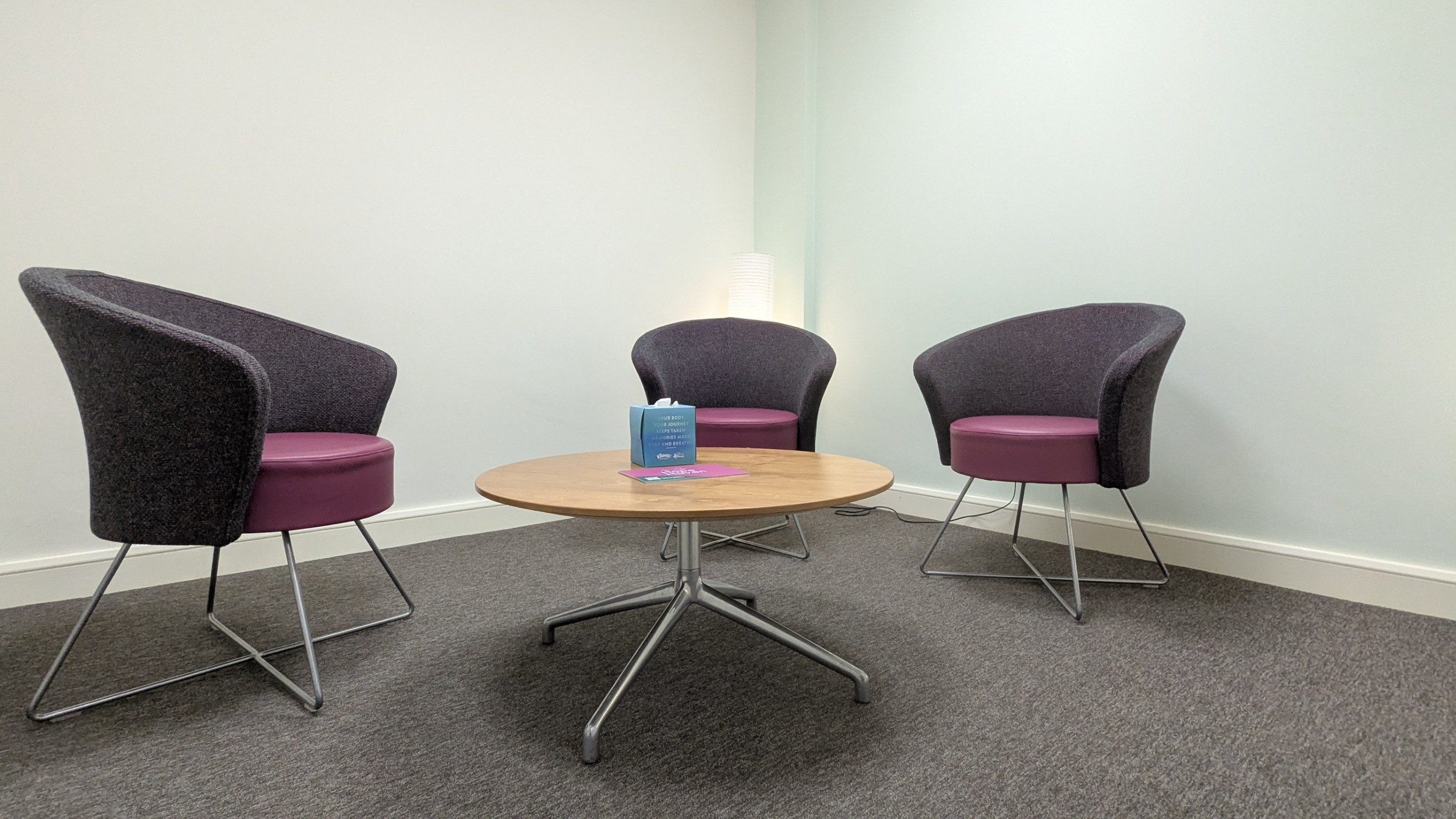 One of the private rooms at Hope Haven, a smaller room with three comfy chairs and a floor lamp