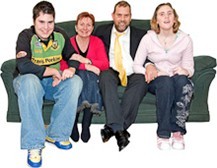 Four people sitting on a sofa