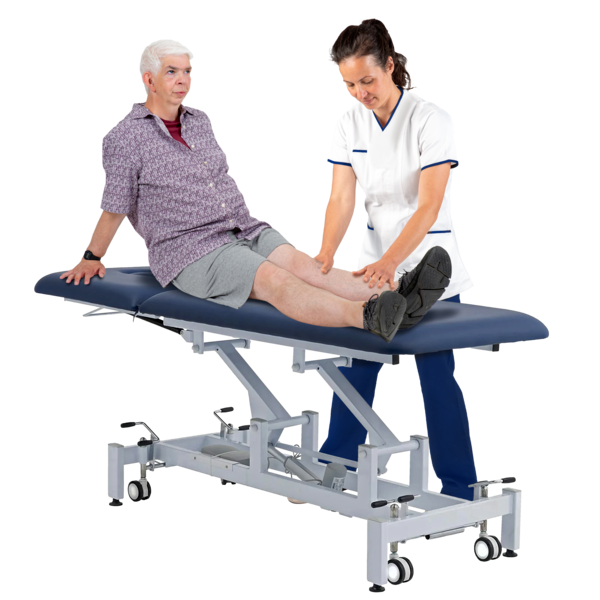 A person sitting on a treatment table being treated by a physiotherapist