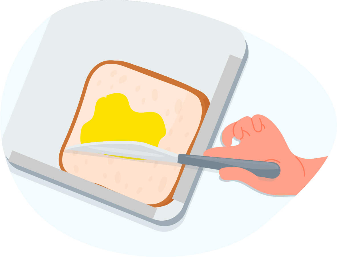 Person spreading butter on a slice of bread that is sitting on a board with raised edges.