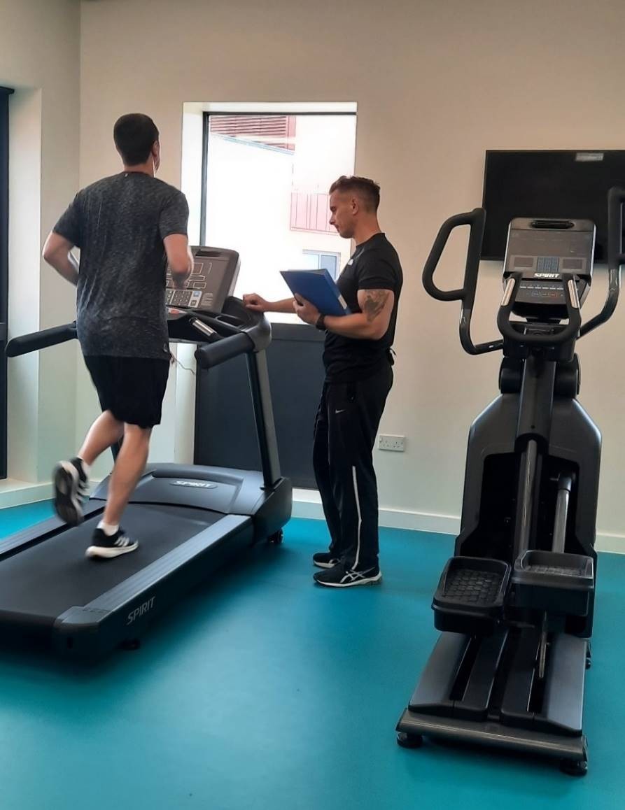 Two people using gym equipment