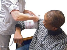 A nurse wrapping a blood pressure cuff around a patients arm