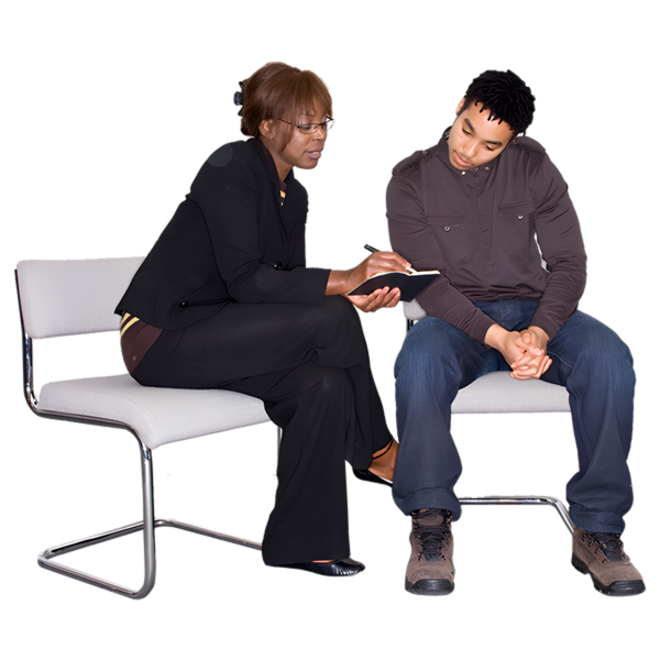Two people seated, one showing something on a tablet to the other.