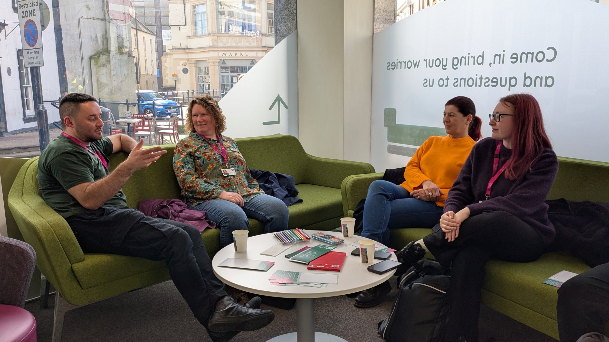 Hope Haven staff sitting on a sofa chatting