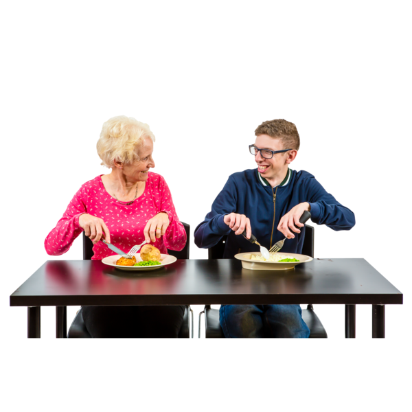 Two people sitting at a table and eating a meal together