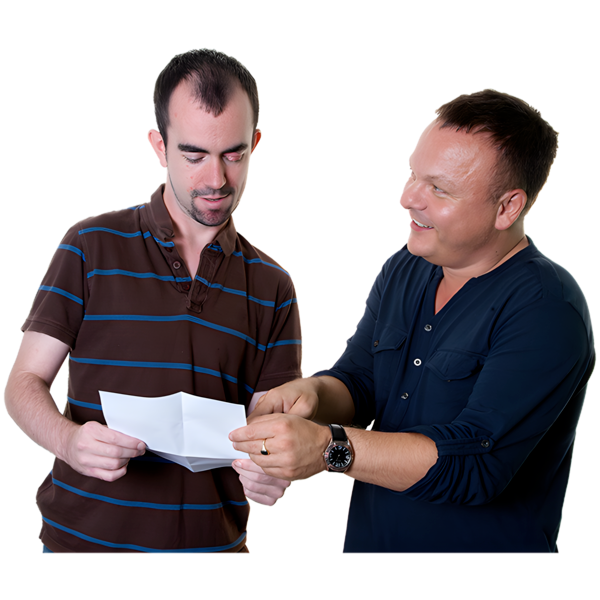 A man is pointing to a piece of paper with another man looking
