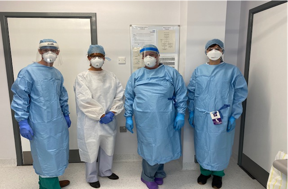 4 members of staff wearing full PPE