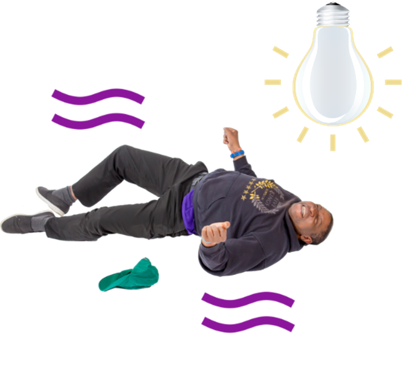 A man is lying on the floor having a seizure. There is a bright glowing light bulb above him.