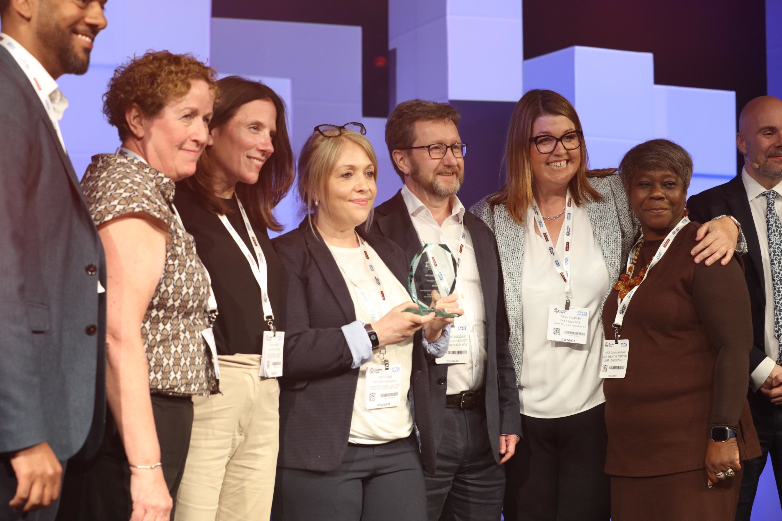 Wellbeing hub team accepting their award on stage