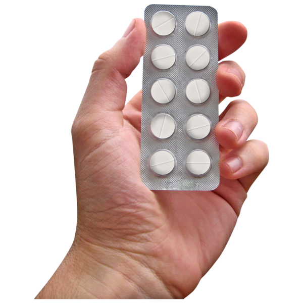 A close up of a hand holding a packet of tablets