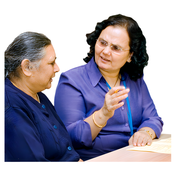 Two women having a conversation at a table.