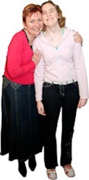 Two people smiling and hugging