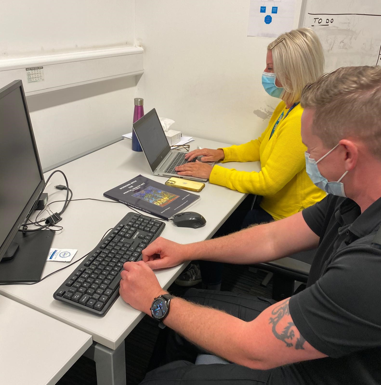 PC Chris Rudd and Registered Mental Health Nurse Deborah Mawson at a desk at the Street Triage Team’s base.