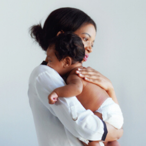 African American mum is comforting a baby on a white background.