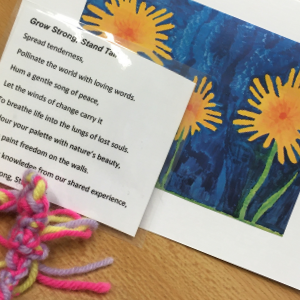 A card with sunflowers painted on it, a laminated poem, and a friendship bracelet.