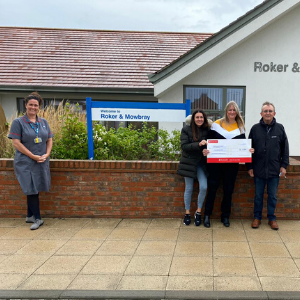 Jean’s daughters Janine Brown (left), Danielle Lister (centre) and her husband Barrie Brown (right), presenting the cheque in line with social distancing guidelines to Marie Smith, Clinical Manager for Inpatient Services South of Tyne (far left).
