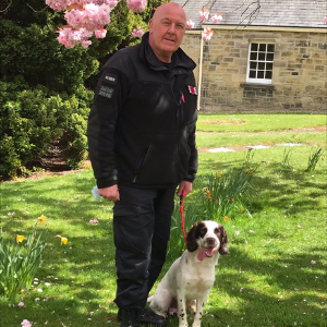 Dog Handler John McCarroll with Sid, Springer Spaniel, in the grounds of St Nicholas Hospital