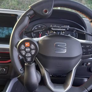 An adapted car steering wheel with an additional control lever to work the windscreen wiper and indicators.