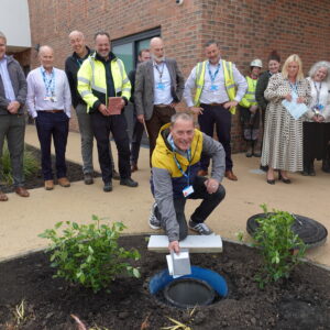 Tom Burton, head of the Woodwork team at Northgate who provide meaningful activity to patients in Secure Care Services, places an item in the capsule.