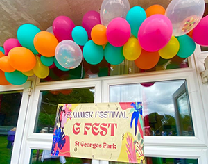 Colourful balloons over a sign that says Summer Festival 'G Fest' St George's Park