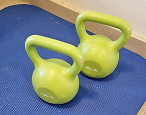 Photos of two kettlebells on a yoga mat
