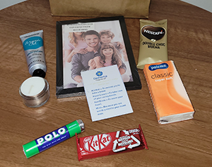 A selection of items in the little bags of love, including chocolate and hand cream.