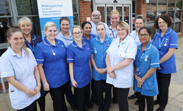 Photo showing nurse team standing together outside for a group photo.
