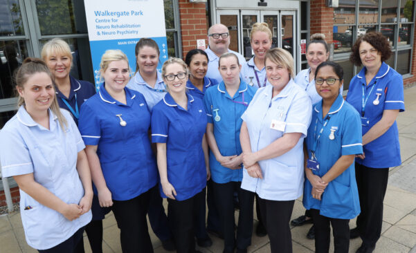 Photo showing nurse team standing together outside for a group photo. 