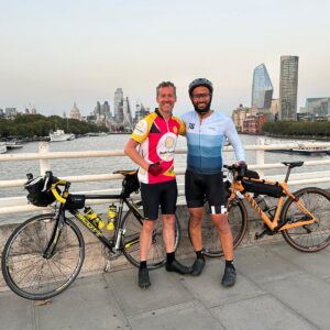 Collegues Paul and Mohammed standing with their bikes
