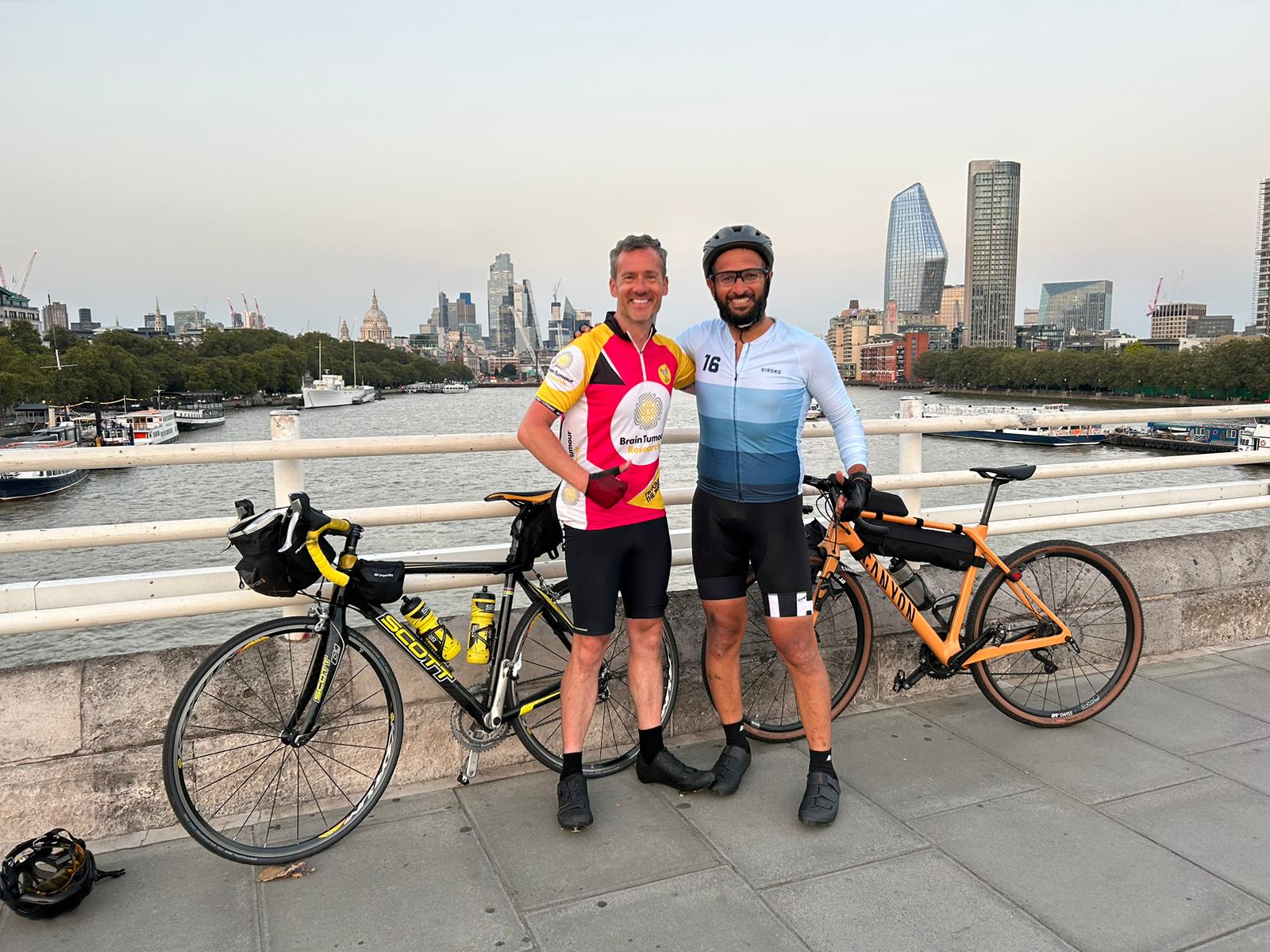 Collegues Paul and Mohammed standing with their bikes