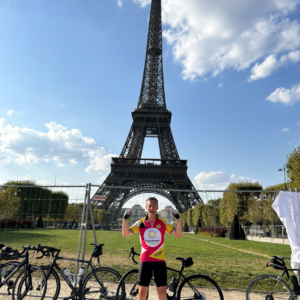 Paul posing under the Eiffel Tower