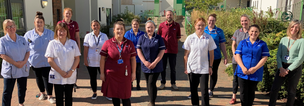 Children and Young People services staff standing together outdoors in the sunshine